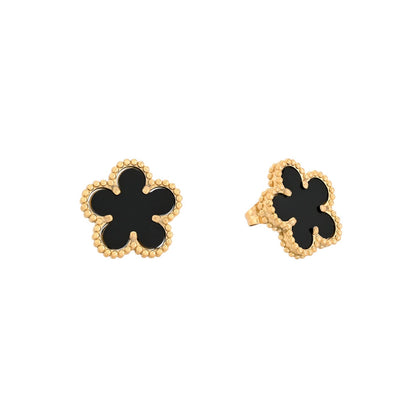 Gold-tone steel earrings with a black clover.